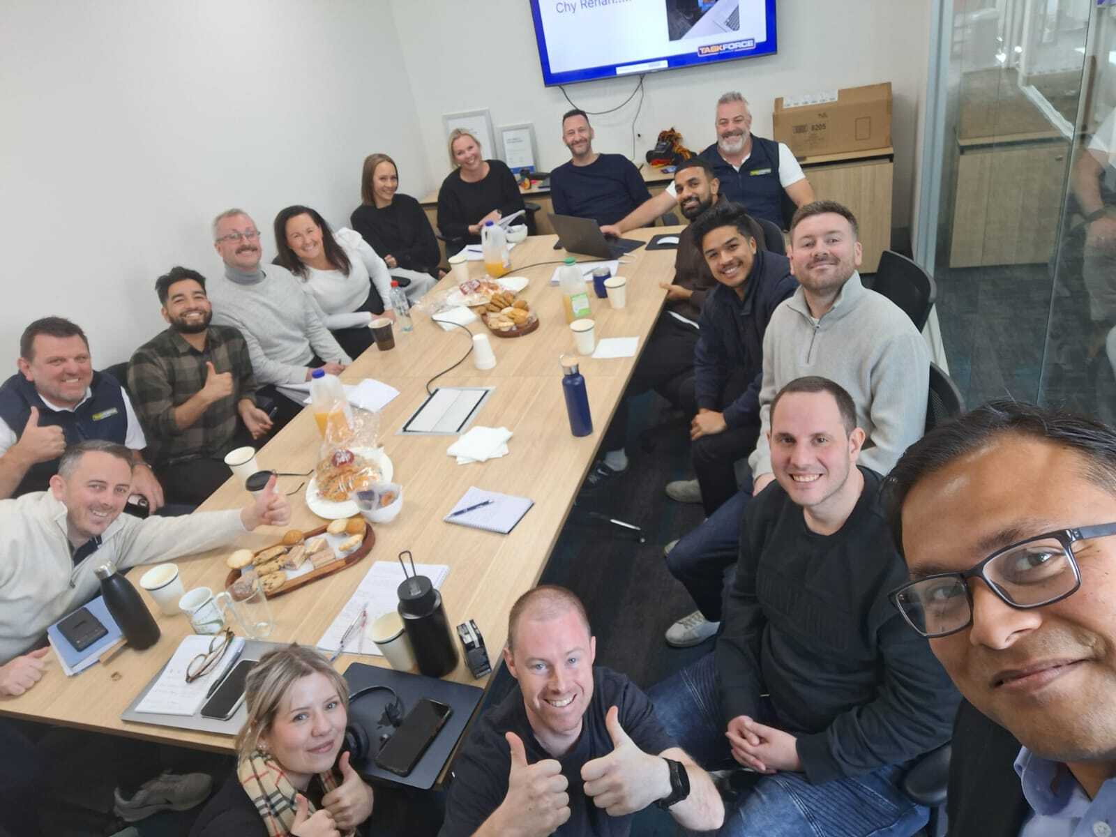 Taskforce Australia team members at team meeting with snacks in boardroom in office in Burnley Victoria 